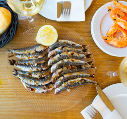 Grilled on fire sardines with lemon, popular andalusian dish