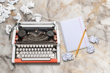 Old retro typewriter with notebook and crumpled paper