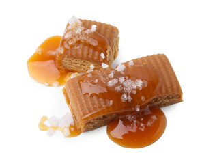 Yummy caramel candies and sea salt isolated on white