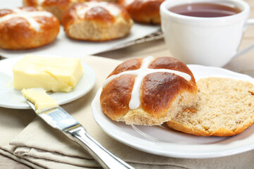 Tasty hot cross bun served on table, closeup