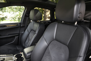 Clean leather seats inside of modern black car