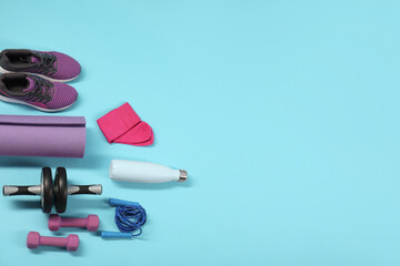 Different sports equipment on light blue background, flat lay. Space for text
