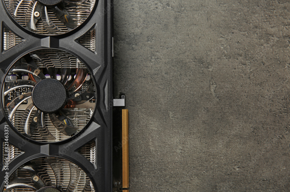 Fototapete one computer graphics card on grey textured table, top view. space for text
