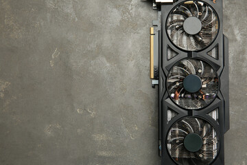 One graphics card on grey table, top view. Space for text