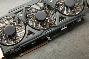 One computer graphics card on grey textured table, above view