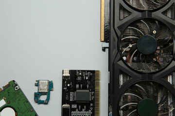 Graphics card and other computer hardware on light background, flat lay. Space for text
