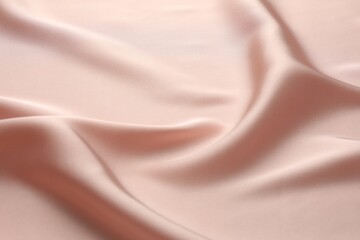 Crumpled pink silk fabric as background, closeup