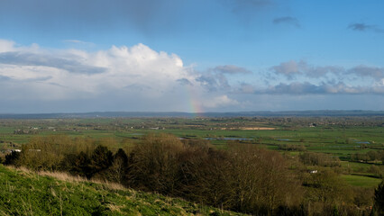 A beautiful rainbow over the Somerset Levels in the rural countryside of Glastonbury, England UK