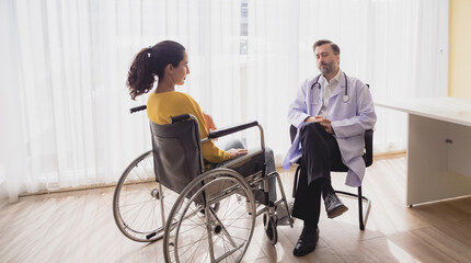Portrait health care latin american woman sick sit wheelchair with man doctor caucasian two people check and treat patients talk help support explain medicine sick person inside hospital clinic room
