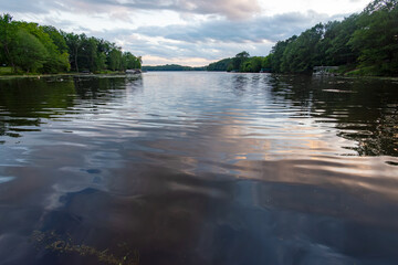 Looking out onto a Wisconsin northwoods lake as the last rays of sunlight begin to fade.  Many boats have returned from fishing for the evening