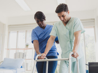 Obraz premium Portrait patient caucasian man sit wheelchair with woman nurse black people carer physical therapist two person talk helping support give advice feel relax smile happy in hospital clinic room service.