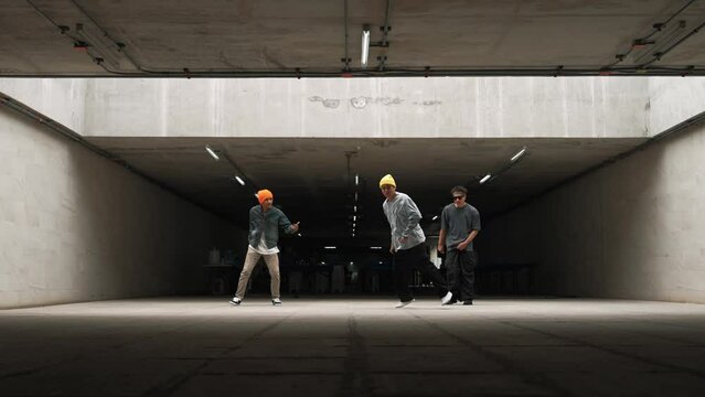 Group of hipster doing freeze pose while dancer team dancing together. Professional break dancer team perform street dance at building with funny and lively movement. Outdoor sport 2024. Sprightly.