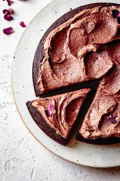 Chocolate cake with chocolate frosting and dried rose petals