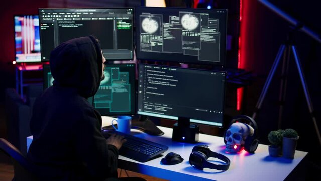 Frustrated hacker in secret hideout dejected after failing to attack victims using malware. Annoyed scammer feeling upset after being unable to hack computer systems, camera B