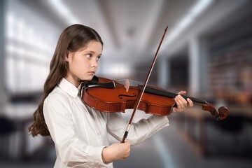 Schoolgirl learning to play in music class