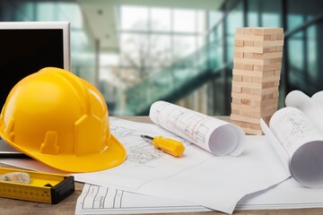 Construction engineer working blueprint on the desk