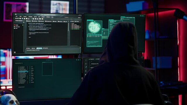 Experienced hacker writing lines of code on computer from underground bunker, tying to get past security systems. Rogue programmer building scripts that can hack devices, camera A