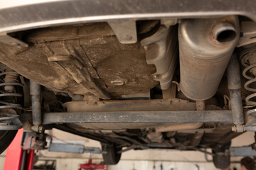 car in the garage, bottom view of the bottom and exhaust pipe. transport service monitoring