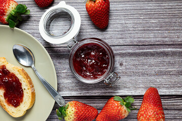 Tasty and healthy homemade strawberry jam. Close-up view of healthy breakfast with homemade strawberry jam in a glass jar
