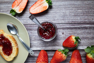 Tasty and healthy homemade strawberry jam. Close-up view of healthy breakfast with homemade strawberry jam in a glass jar