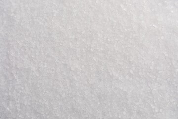 White natural salt as background, top view