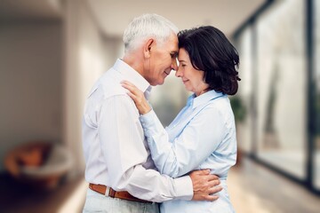 Fototapeta premium Happy loving senior couple standing at home
