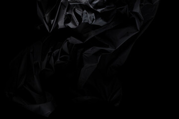 Black wrinkle mussed fabric flying in curve shape, Piece of textile Black wrinkle mussed fabric...