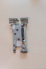 Close-up of a metallic hinge mechanism with a bolt and spring