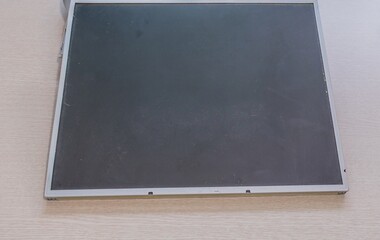 Black screen of an electronic monitor on a plain surface