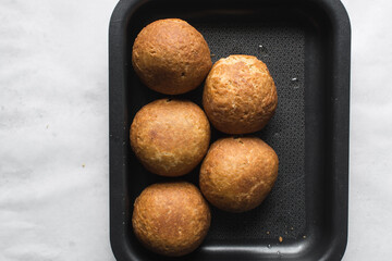 Overhead view of homemade nigerian egg roll, freshly made african egg roll in a baking tray, flatlay of egg wrapped in fried dough
