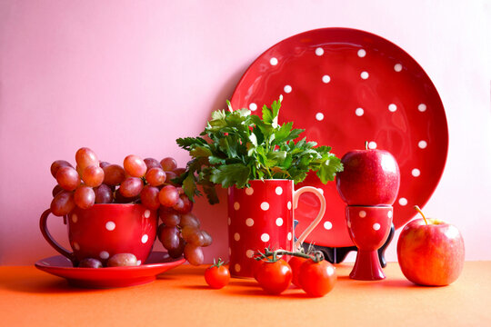 Red fruits and vegetables with red polka dot tableware, color blocking aesthetic. Red foods contain powerful healthy antioxidants, lycopene, anthocyanins, vitamin C and can boost immunity.