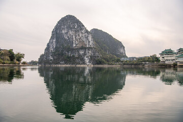 Two beautiful limestone mountains surrounded by the river and village houses