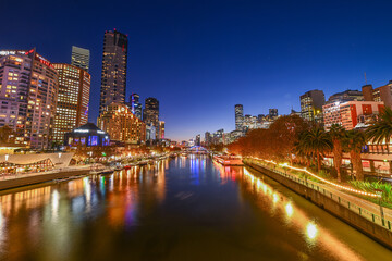 A view of the Melbourne Skyline behind the Yarra River at sunset