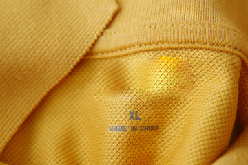 clothing label made in china on a yellow color shirt 