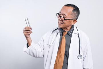 Potrait Of Smiling Senior Male Doctor Looking At Medicine Wear Glasses Isolated On White Background