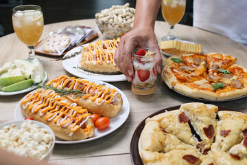 Hands Preparing To Dinner Party With Assortment Food. Hand Taking Strawberry Parfait