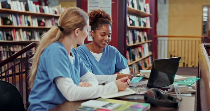 Medical students, women and study with notes in library for school, knowledge and conversation together with smile. Gen z girls, talking and education for cardiology by desk with books and learning