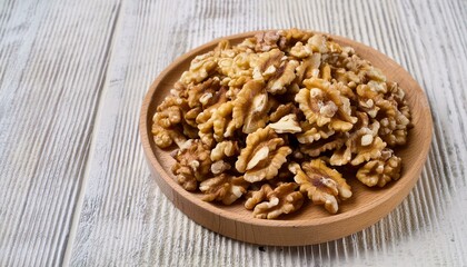 Fototapeta premium Wholesome Walnuts: Top View Close-Up on Wooden Plate