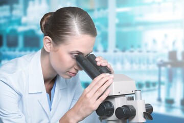 Young researcher working examining samples with microscope