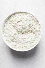 Overhead view of Over proofed dough that has risen over the top of bowl, bread dough that has risen for too long, bread making fail, process of making bread