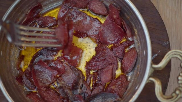 Turkish fried sausage sucuk in a pan
