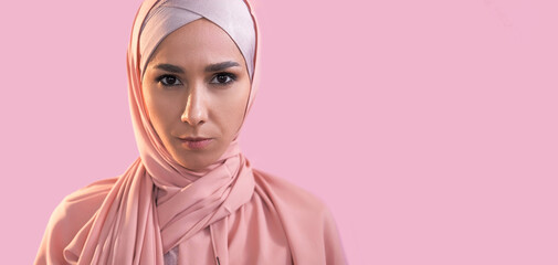 Muslim woman. Islamic face. Portrait of confident serious girl in hijab headscarf isolated on...