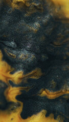 Ink spill. Glitter fluid mix. Defocused black golden yellow color shimmering wet paint flow bokeh light texture abstract art background.