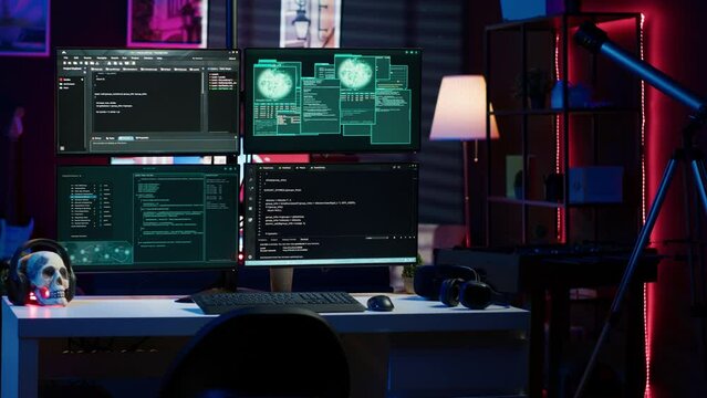 Panning shot of high tech computer system running malicious code in empty apartment. PC monitors in empty neon lit criminal hideout used by hackers to commit illegal activities