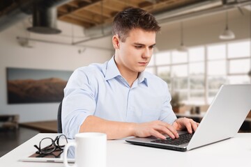 Smiling busy business man analyzing finance at office