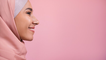 Cheerful face. Happy expression. Side view portrait of optimistic smiling woman in headscarf...