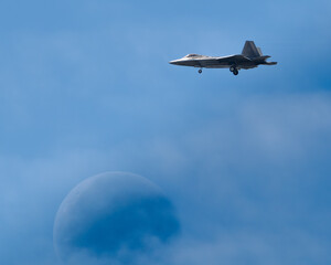 Fighter aircraft with Moon in Clouds