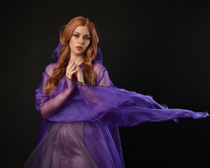 close up portrait of beautiful female model with long red hair, wearing a purple fairy  fantasy...