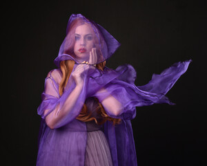 close up portrait of beautiful female model with long red hair, wearing a purple fairy  fantasy...