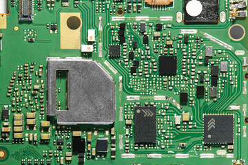 a green printed circuit board full of soldered components